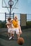 Two teenage players with basketball