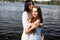 Two teenager girls sitting on a pier at the river bank having good time in summer. happy girl friends relaxing outdoor near lake.