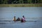 Two teenager girls swimming in the lake with the horses