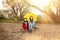 Two teenager with umbrella sitting on a dirty beach