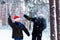 Two teenagers in Christmas hats Santa Claus having fun in the sn