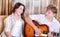 Two teenagers singing by guitar