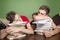 Two teenagers sleeping on books