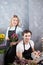 Two teenagers working as florists on grey background