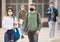 Two teens in protective masks walk along street