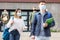 Two teens in protective masks walk along street
