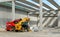 Two telescopic handlers inside a concrete block building under construction.