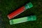 Two test tubes with colored liquids on green moss