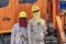 Two Thai male electricians in sun protection masks stand next to a technical vehicle in island Koh Phangan, Thailand