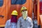 Two Thai male electricians in sun protection masks stand next to a technical vehicle in island Koh Phangan, Thailand