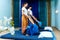 Two thai masseuses synchronously doing thai massage.