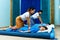 Two thai masseuses synchronously doing thai massage.