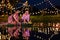 Two thai woman holding a krathong sitting on a raft by the river, Asian women in traditional Thai costumes bring krathongs to