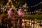 Two thai woman holding a krathong sitting on a raft by the river, Asian women in traditional Thai costumes bring krathongs to