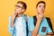 Two thoughtful teenagers, guys who are trying to find the right solution or make plans, on a yellow background