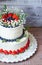 two-tier cream cheese wedding cake with blueberries and strawberries