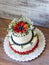 two-tier cream cheese wedding cake with blueberries and strawberries