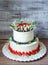 two-tier cream cheese wedding cake with blueberries and strawberries