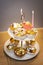 Two-tier plate with children`s decorated birthday muffins