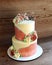 Two-tier sponge cake decorated with buttercream flowers for a wedding.