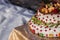 Two-tiered cake with fruits and chocolate (half cake)