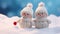 Two tiny knitted snowmen in winter landscape against blue bokeh background