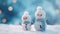 Two tiny knitted snowmen in winter landscape against blue bokeh background