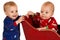 Two toddler boys in winter pajamas in a sleigh