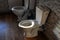 Two toilets in the attic of a residential building. Children`s toilet