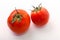 Two tomatoes on white