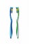 Two toothbrushes, blue and green on a white background