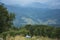 Two tourist girls sit on the mountainside