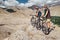 Two tourists with bikes explore Himalaya mountain region