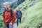 Two tourists climbs in mountain under the rain