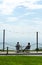 Two tourists sit at a table on the promenade, looking out to sea,  at the charming Welsh seaside resort of Criccieth