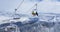 Two tourists skiing in Park City ride the chairlift to the top of the mountain.