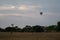 Two tourists watches the hot air balloons in the sky, Bagan, Nyaung-U, Myanmar