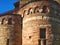 Two towers. Antique architecture. Round walls with windows. Red bricks, texture house, pattern on the walls. History monument cast