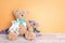 Two toy bears of parent and child on yellow background. Parenthood concept. Copy space.