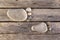 Two traces of feet made of pebbles over wooden planks