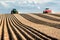 Two tractors with planting implements planting potatoes in the farm fields of Idaho