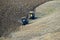 Two tractors plow the field with a September sunny day