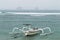 Two traditional Bali fishing boats on big waves in storm and raining