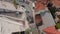 Two tram cars passing by each other in narrow town street. Aerial view from drone. Lisbon, capital of Portugal.