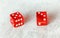 Two translucent red craps dices on white board showing Easy Eight number 5 and 3
