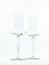 Two transparent elegant crystal glasses for cocktails and wine on a white background