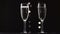 Two transparent glass of chilled sparkling wine. Bokeh blinking black background