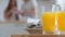 Two transparent glasses with orange mango natural tropical fruit juice drink stands on table in home kitchen near