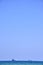 Two transport ships on the horizon with blue sky in the background during vacation in Cyprus