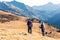 Two travel hikers with backpack walking while looking the landscape in the mountain. Back view